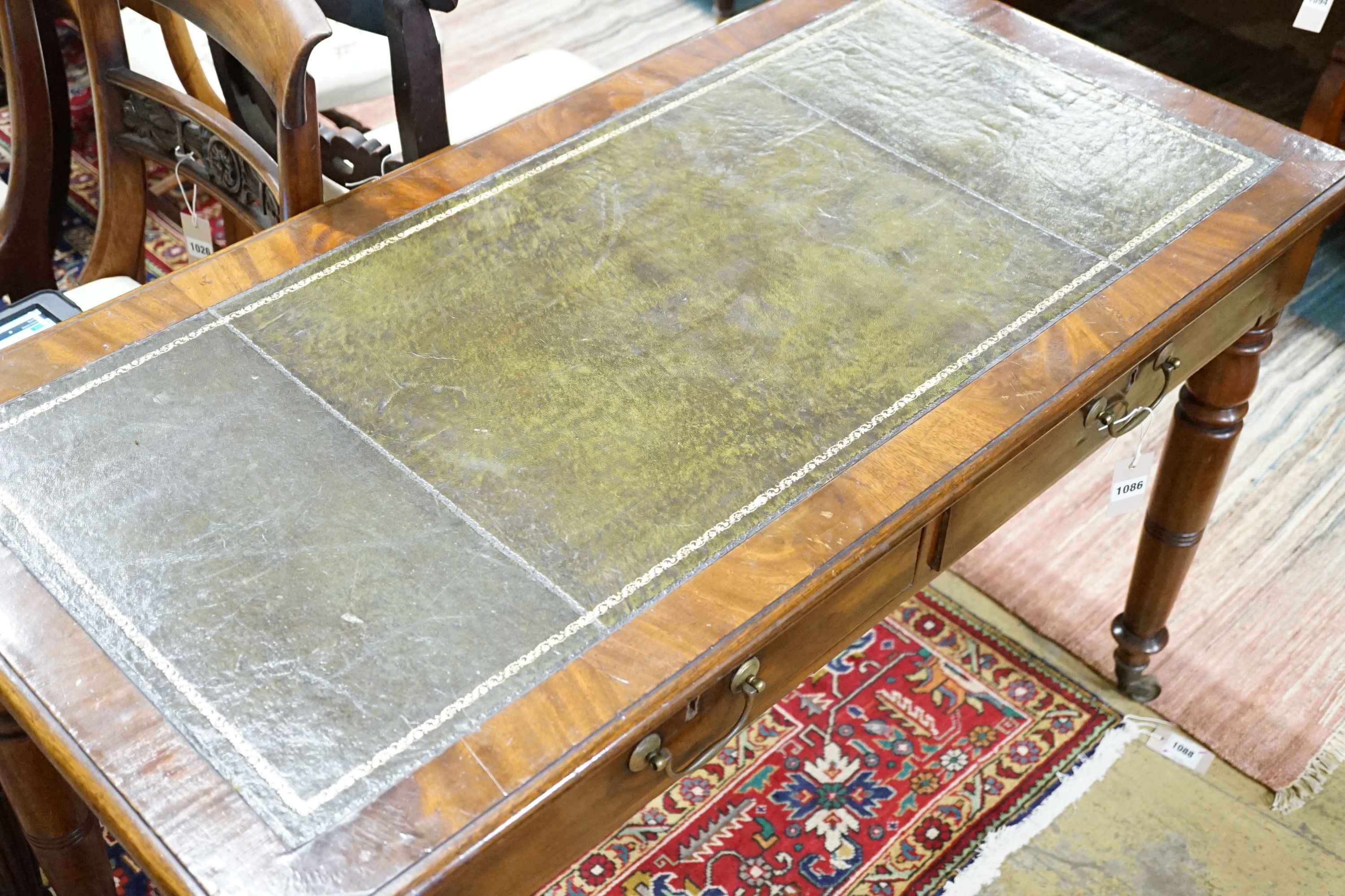 A late Victorian mahogany writing table, width 115cm, height 74cm
